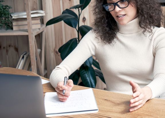 A delegate taking notes within a virtual conference